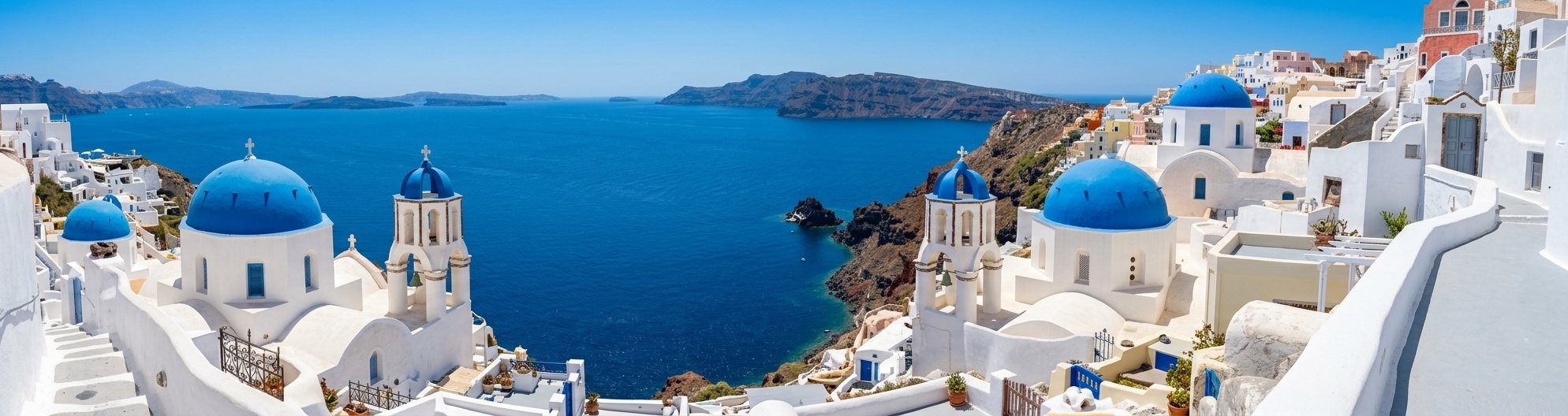 Blue-domed churches of Santorini above the Aegean Sea